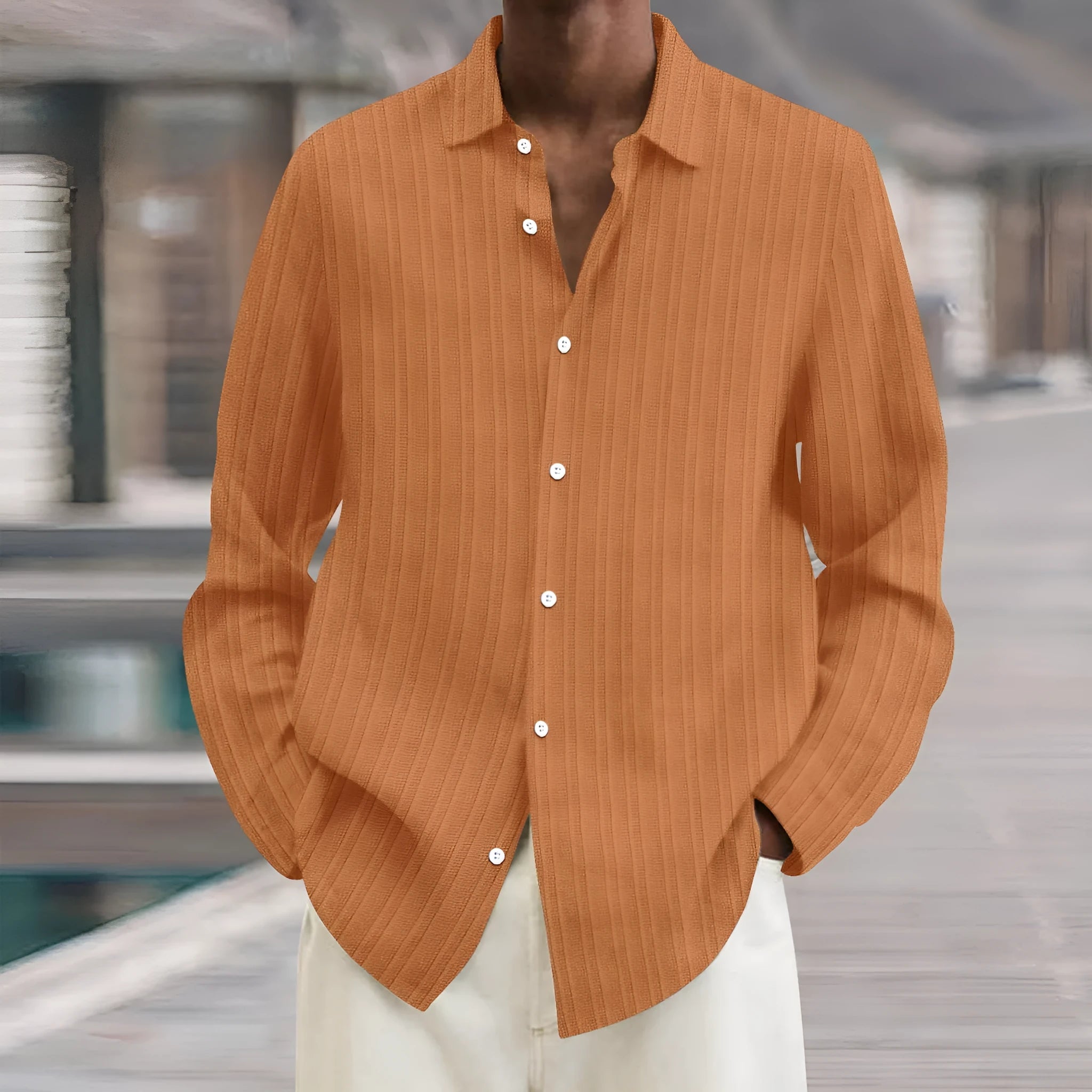 Man wearing a loose fit striped cardigan shirt in British style with a 3D pattern.