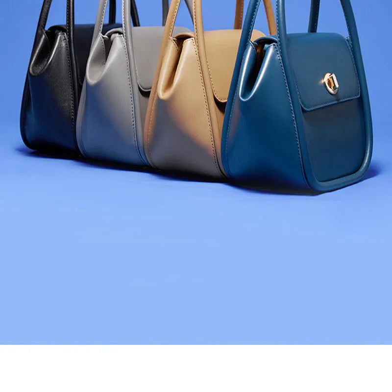 Women's wing-shaped leather tote bag with latch closure and cross-body strap in four colour options