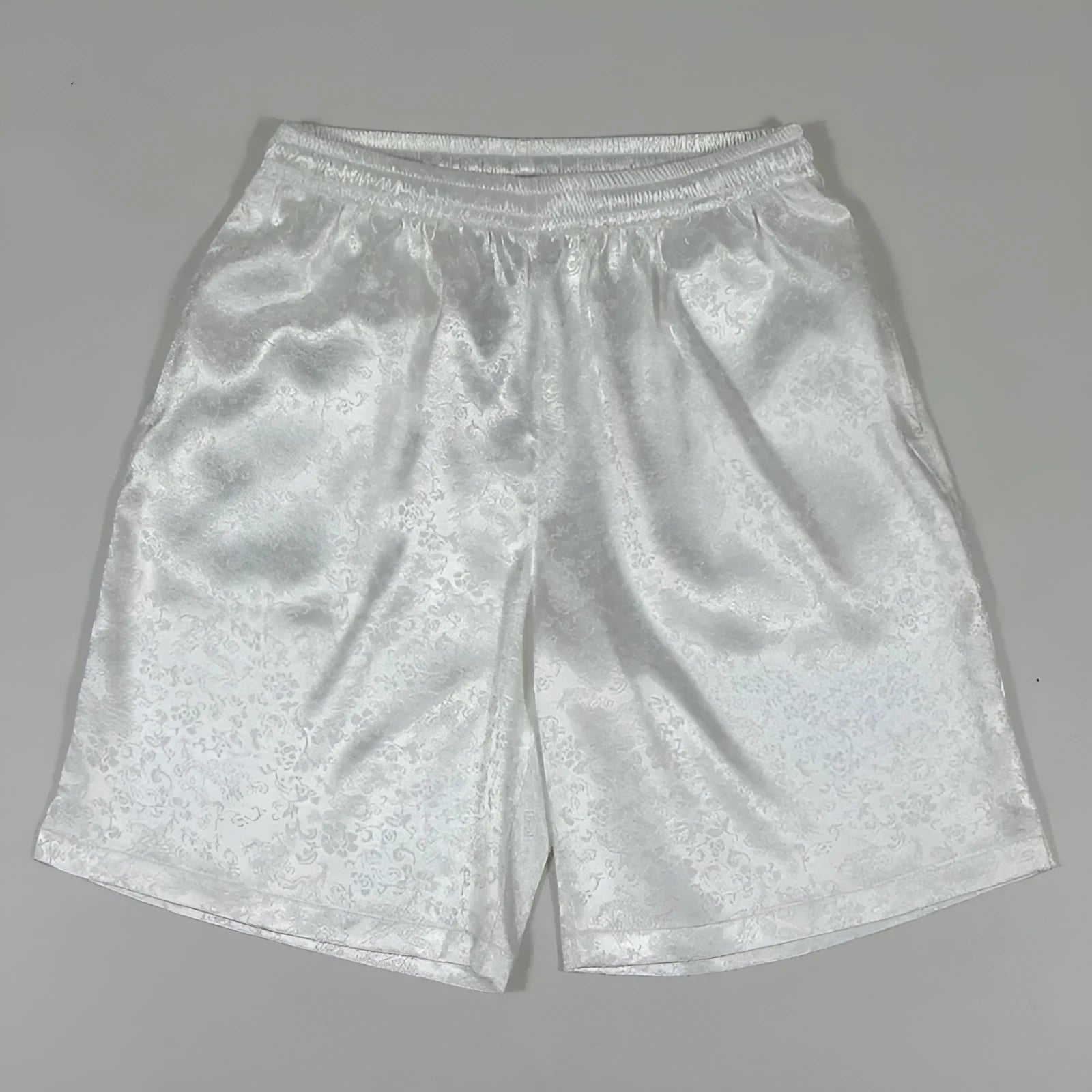 Men's black Tai Chi shorts with an elastic drawstring waistband on a white background.