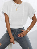 White knitted pullover sweater with ruffled short sleeves created from twisted string, shown in a loose fit.