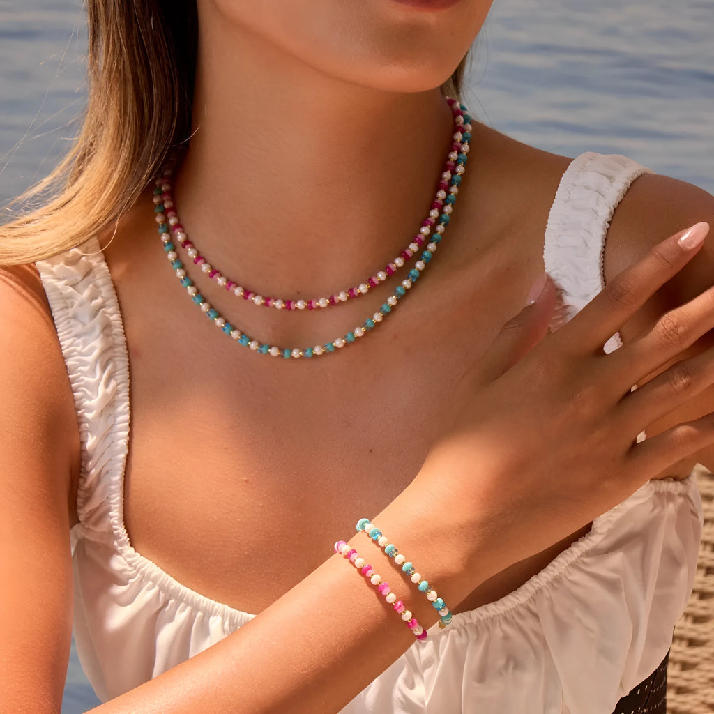 18K gold plated stainless steel chain necklace with pink electroplated resin bead pendant on white background