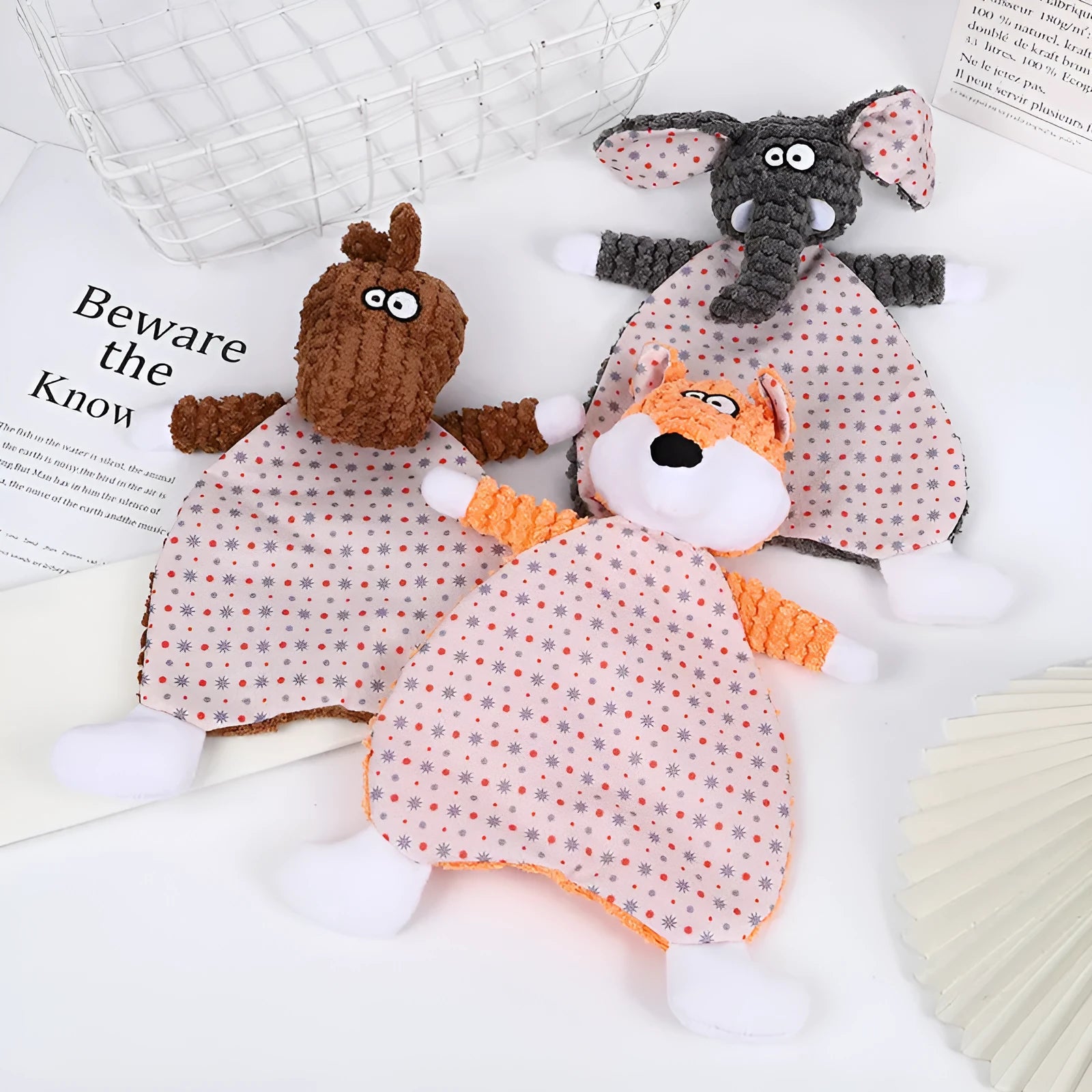 Pet stuffed toy showing fox, elephant, and dinosaur designs in brown, grey, and orange colours with soft velvet material