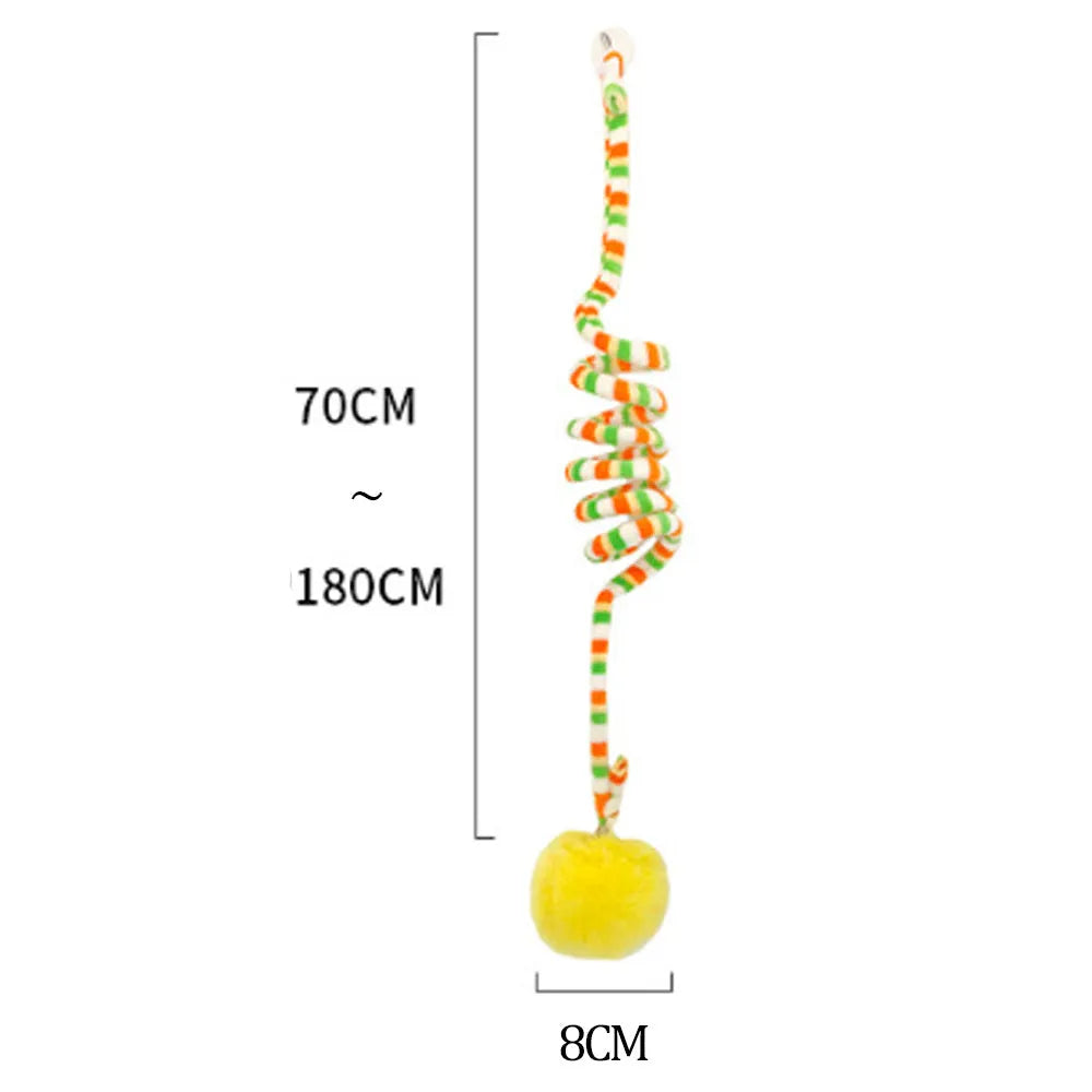Hanging cat toy with bell stick and red inflatable ball attached to a glass door by a suction cup.
