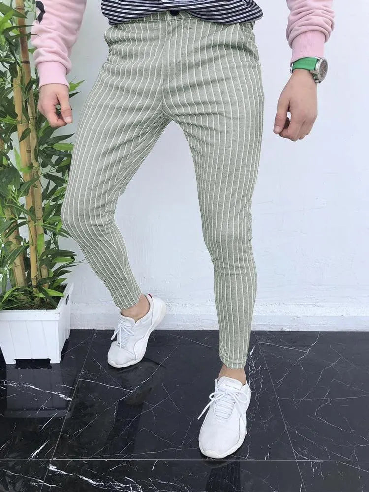 Man wearing slim-fit straight leg casual trousers with a 3D printed plaid pattern in a neutral colour.