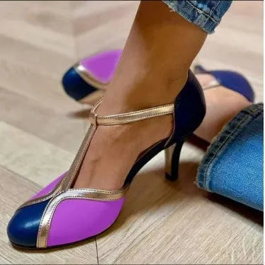 Women's round toe high heels in large sizes with button closure, shown in light blue pink colour.