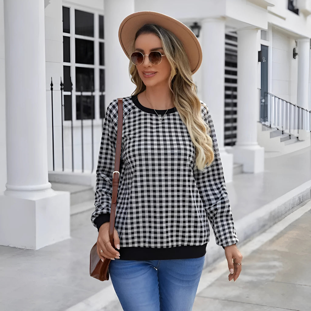 Black Japanese plaid pattern long sleeve polyester pullover sweater on a hanger
