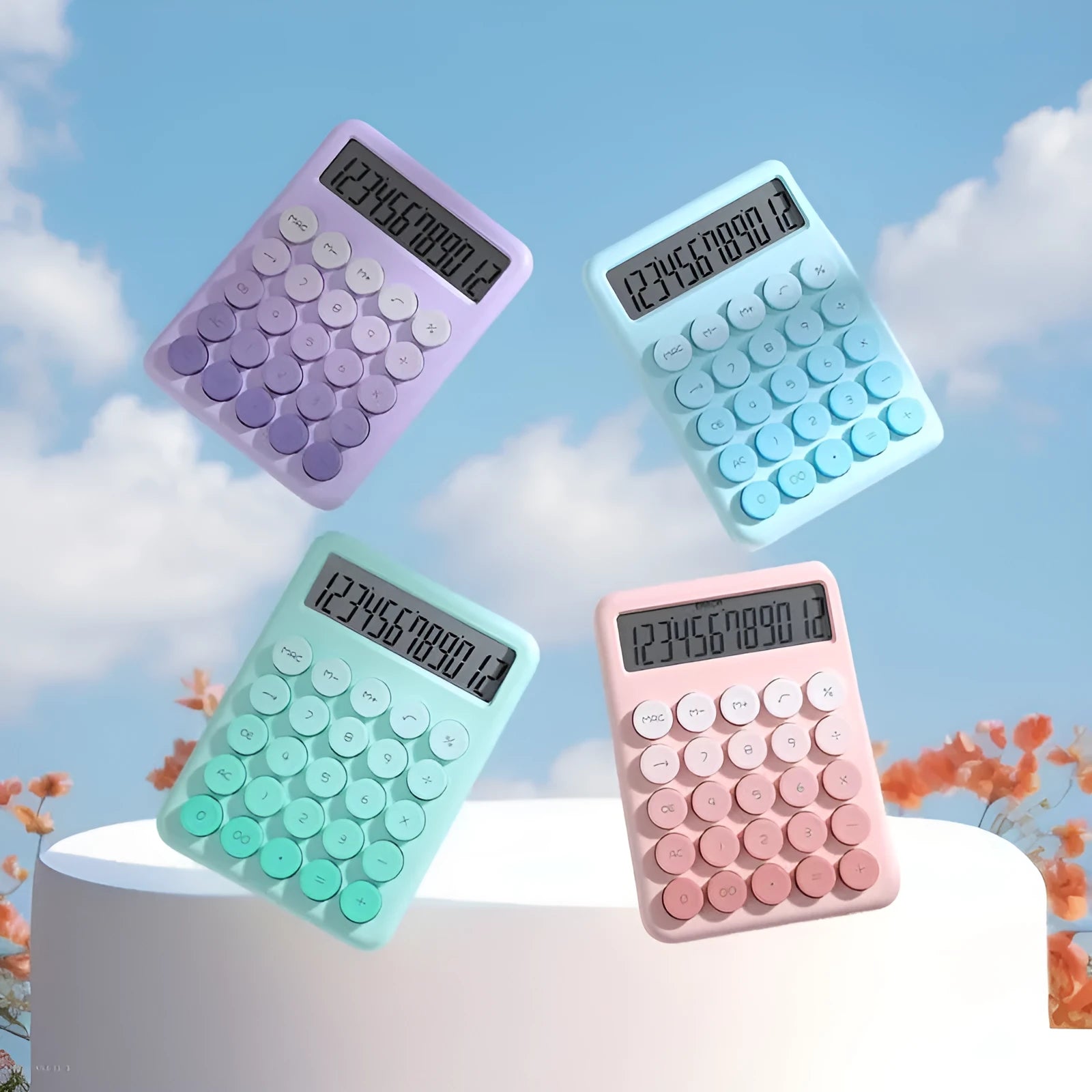 Desktop calculator with a gradient colour design in violet, blue, green, and pink tones on a white desk.