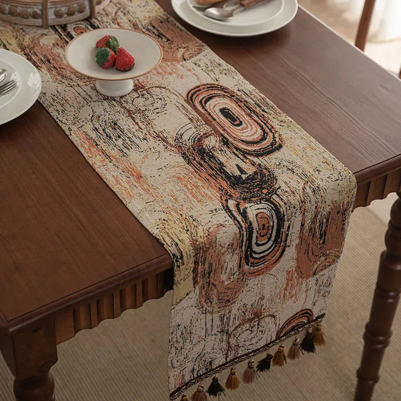 Dark blue Nordic jacquard table runner with bouquet pattern and tassel fringe on wooden table