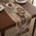 Dark blue Nordic jacquard table runner with bouquet pattern and tassel fringe on wooden table
