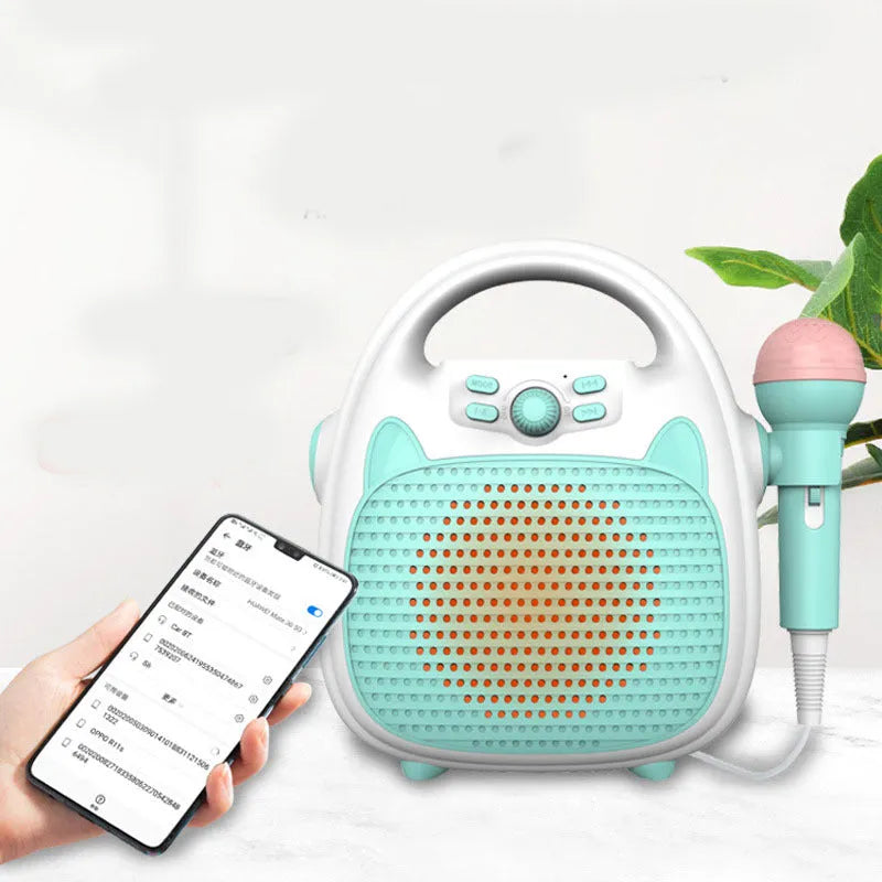 Blue kids karaoke machine with built-in microphone, disco lights, and phone holder on a table