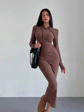 A woman wearing a light grey hooded sheath dress with long sleeves, showcasing the high waist and over-the-knee length.