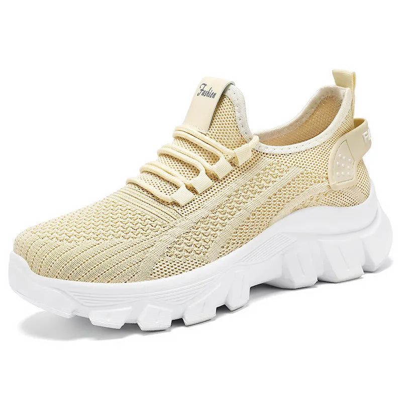 Women's white Flyknit running sneaker with thick PVC sole and lace-up front on a neutral background.