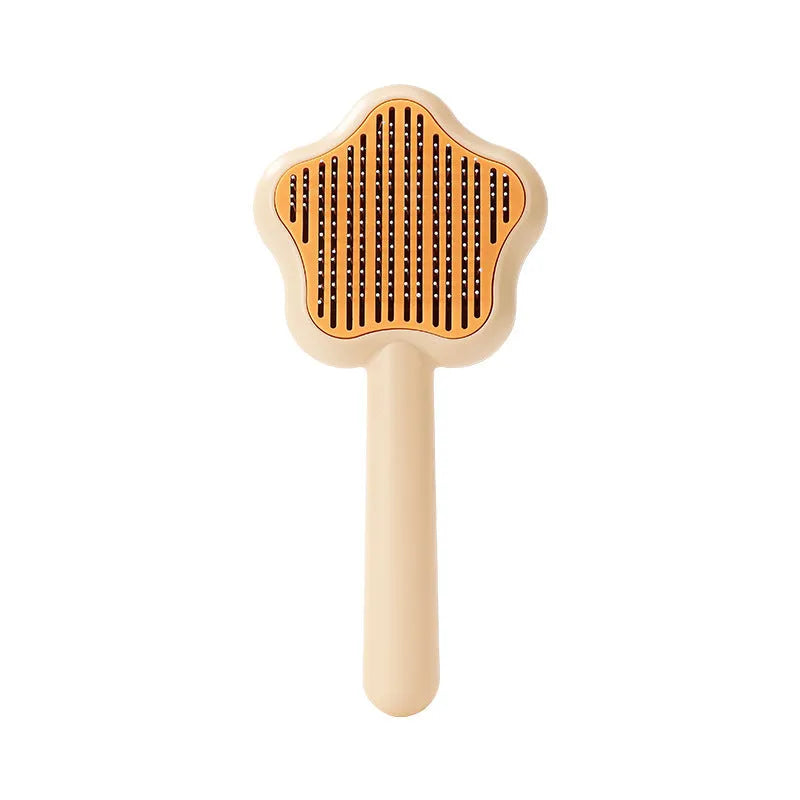 Green and yellow self-cleaning cat grooming comb with stainless steel needles on a white background.