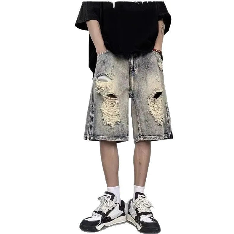 Blue retro tattered denim shorts with a wide leg and loose fit on a hanger.