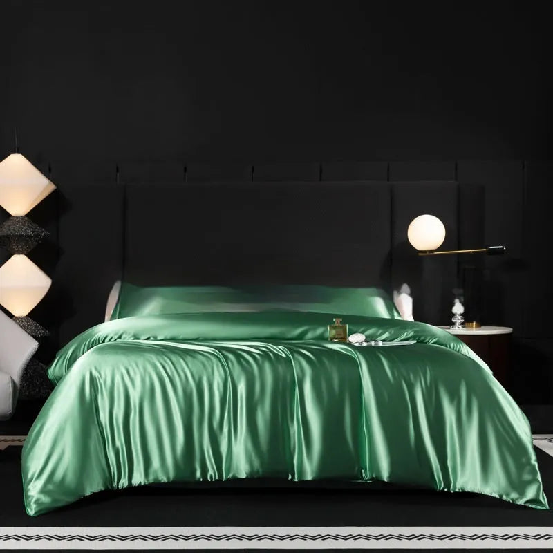 Silk bed sheet four-piece set in solid colour folded, showing options for Ash Purple, Cool Black, and Golden Camel.