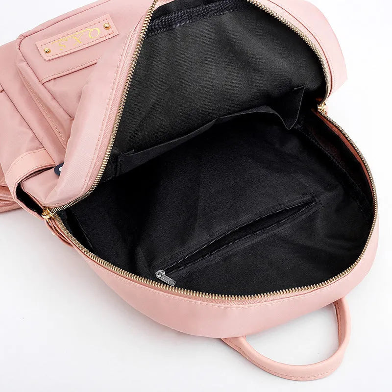 Women's black nylon backpack with double shoulder straps and organisational compartments