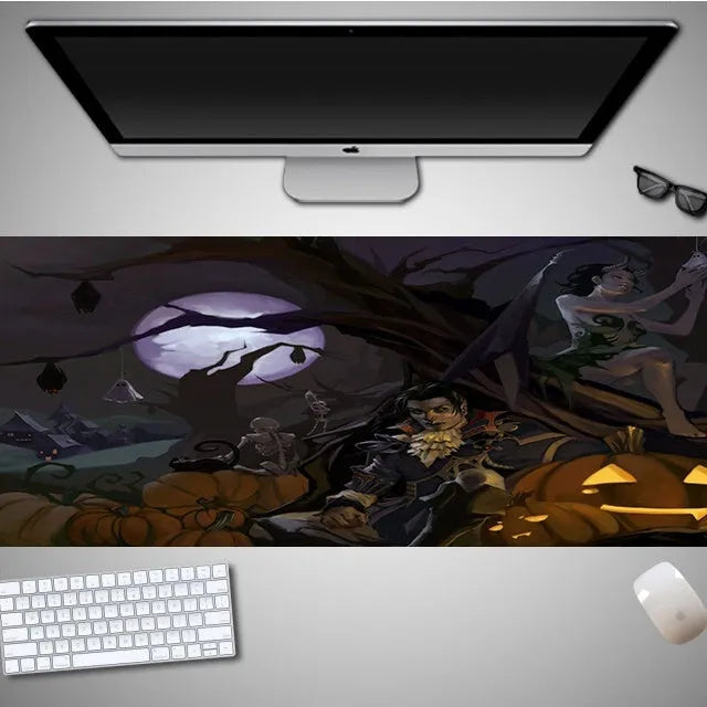 Oversized black Halloween-themed mouse pad with spooky artwork on a desk next to a gaming mouse.