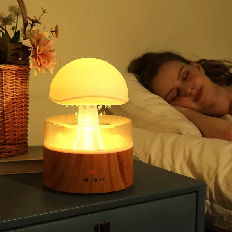 White cloud-shaped humidifier with falling raindrop effect and colour-changing LED lights
