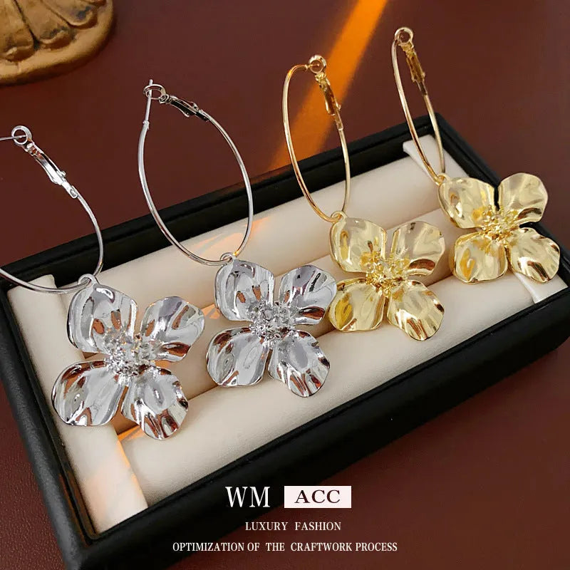 Silver needle metal flower earrings with geometric floral design in gold or silver colour