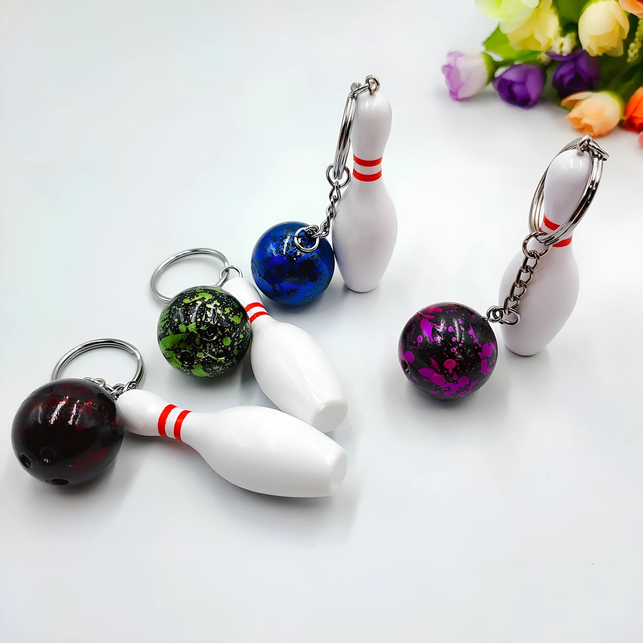 Mini simulation sports bowling pin keychain pendant in blue, dark red, green, or purple colour options.