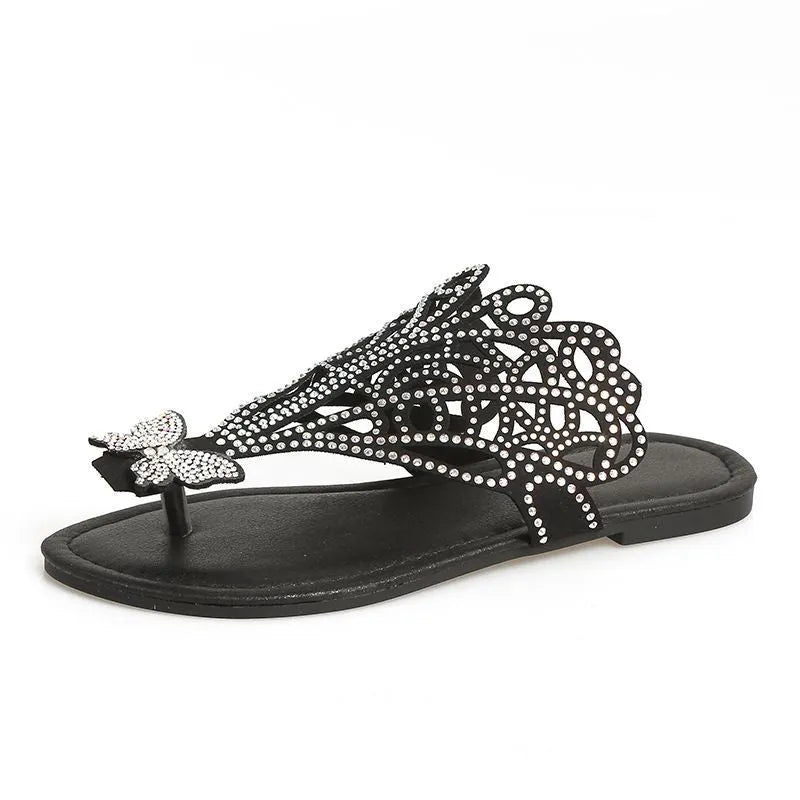 Women's black flip-toe sandals with rhinestone detailing and hollow design on flat rubber sole