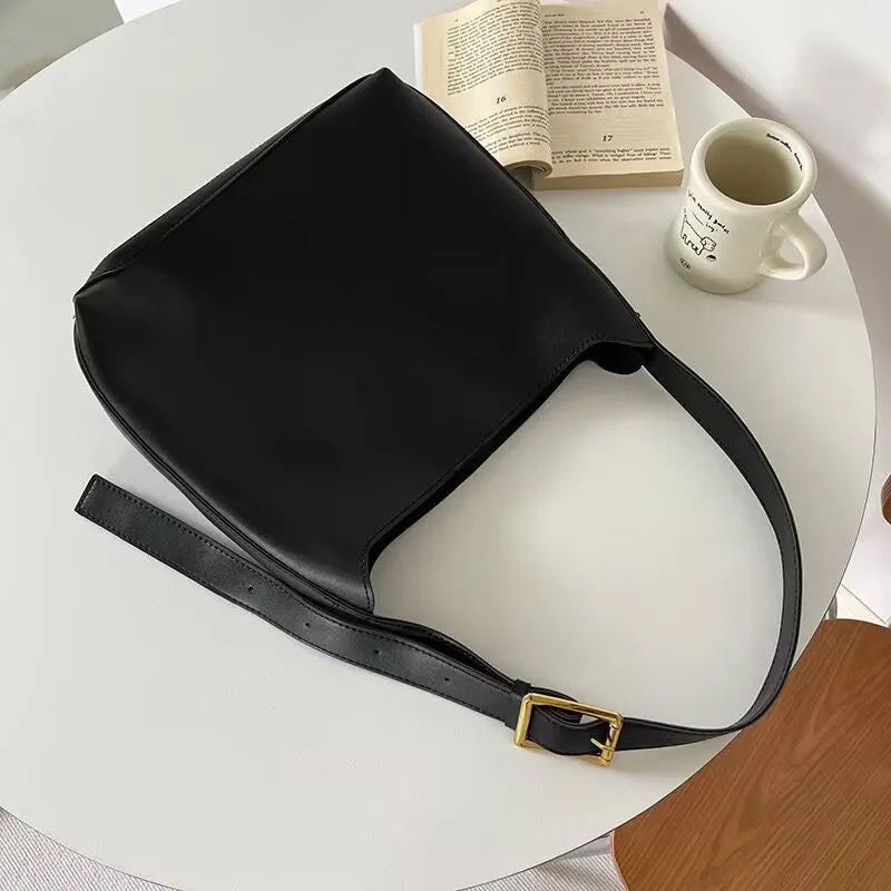 Women's black and brown shoulder bags with swinging threads and soft PU leather construction