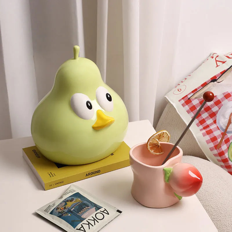 White porcelain pear-shaped tissue box holder in green colour on wooden surface