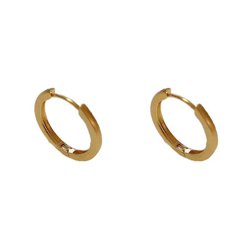 Women's geometric ear clip with round design in gold and silver plated finishes
