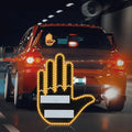 Black plastic LED gesture car light with amber LEDs showing a hand gesture, remote control, and 3M tape for mounting.