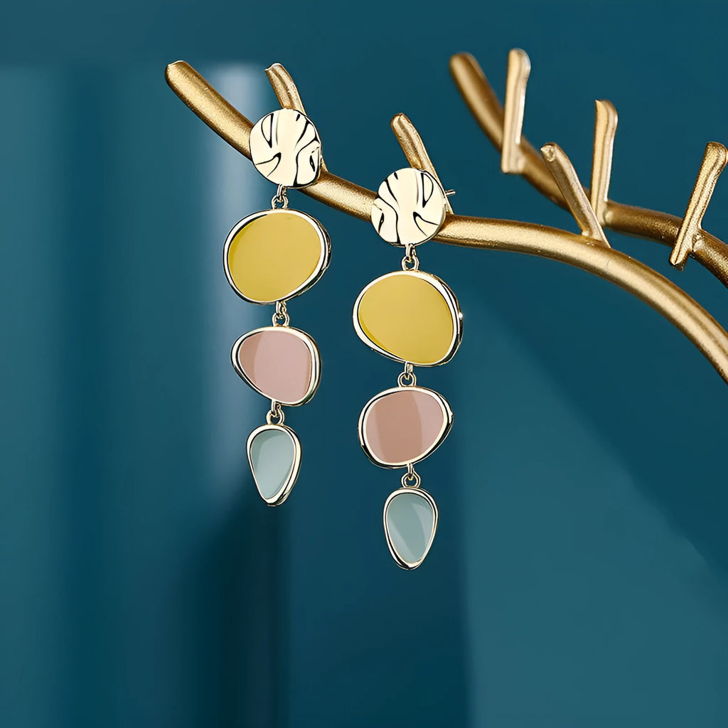A pair of simple disc-shaped alloy earrings with a blended Morandi three-colour oil drip finish.