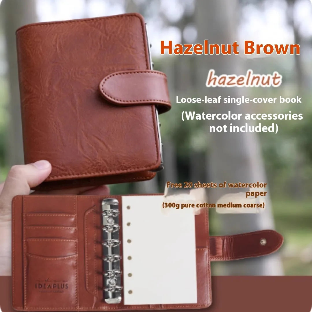 A7 size loose-leaf watercolour notebook in multiple colours, open to show 160gsm paper pages.