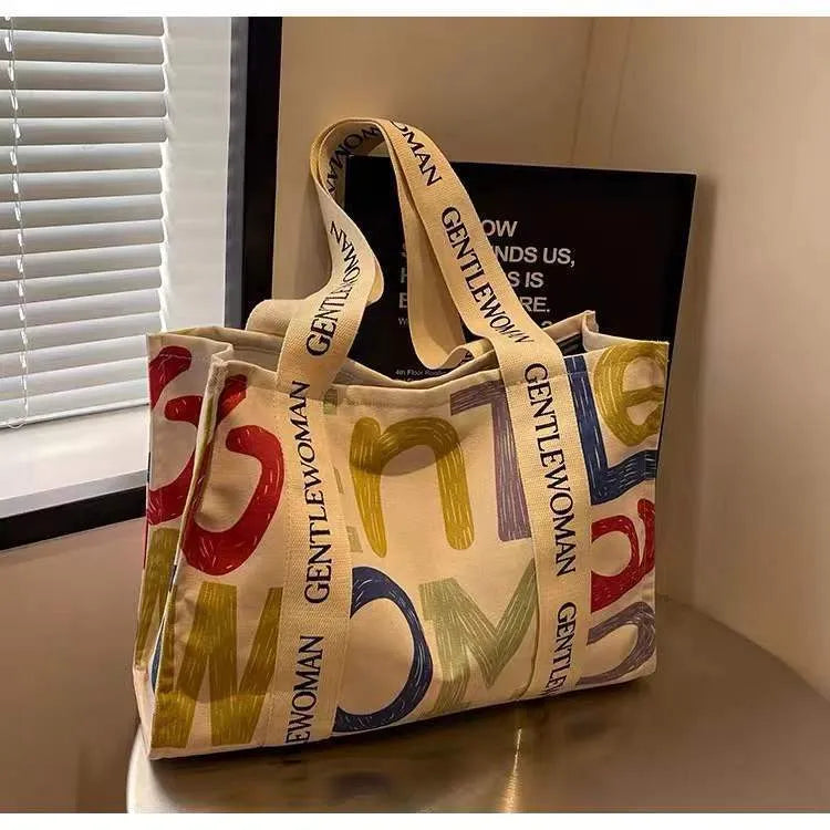 Large canvas tote bag with printed design, shown in multiple colour and pattern options.