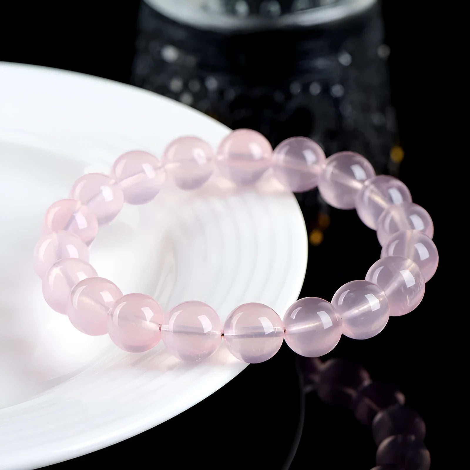 Natural starlight crystal bracelet with round polished pink beads in various size options.
