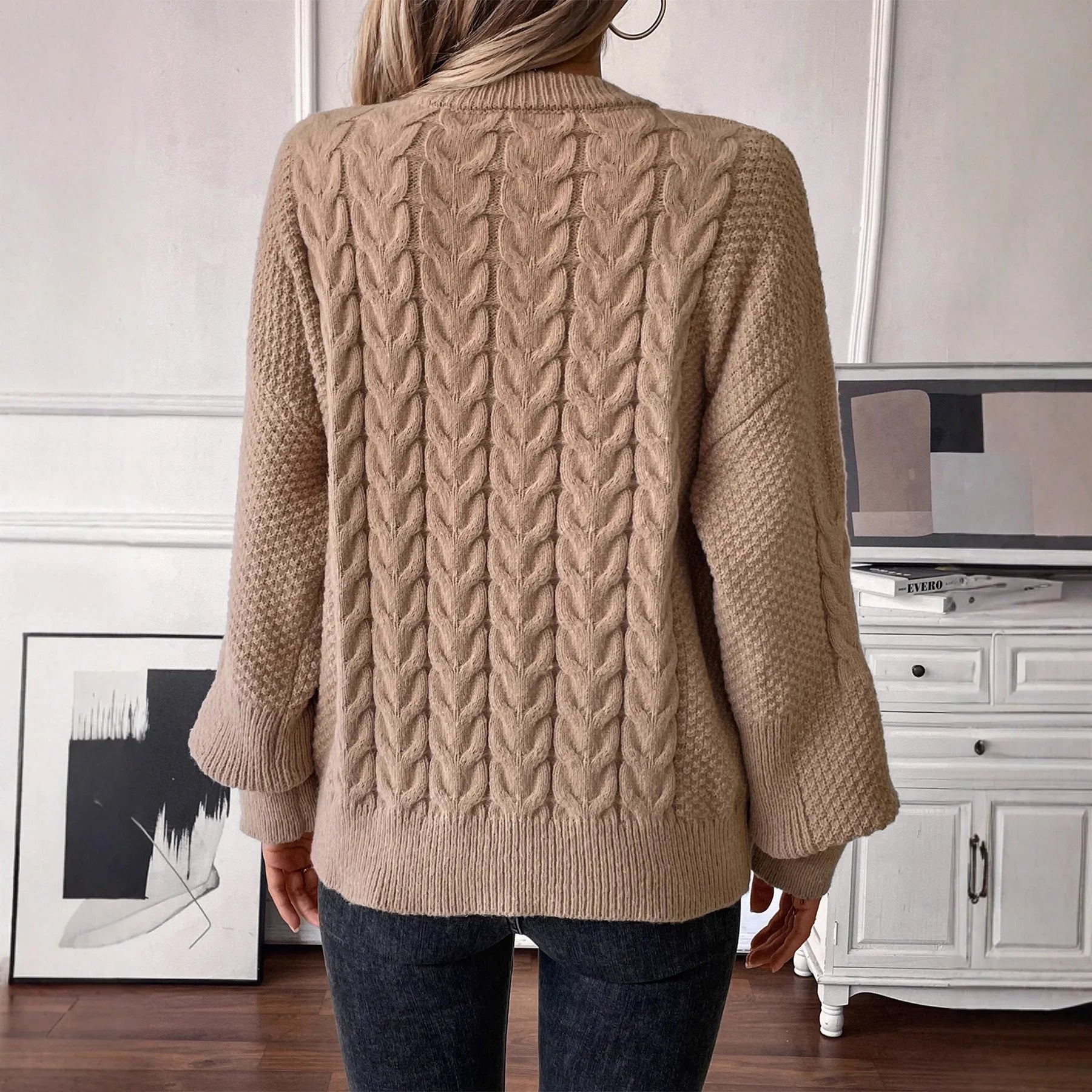 Beige women's loose casual sweater with round neck and a subtle twist design detail on the front