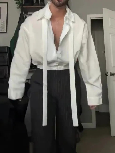 White oversized tie-front shirt with relaxed fit, open collar, and regular-length cut on a plain background