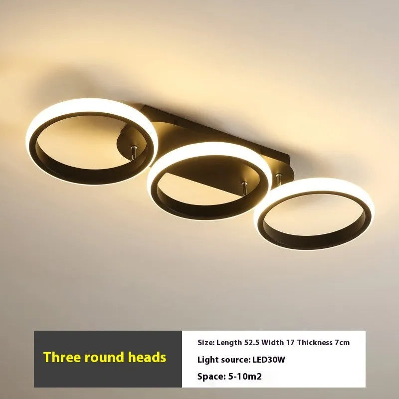 Modern simplicity hallway LED ceiling light in black with three round shapes over a corridor