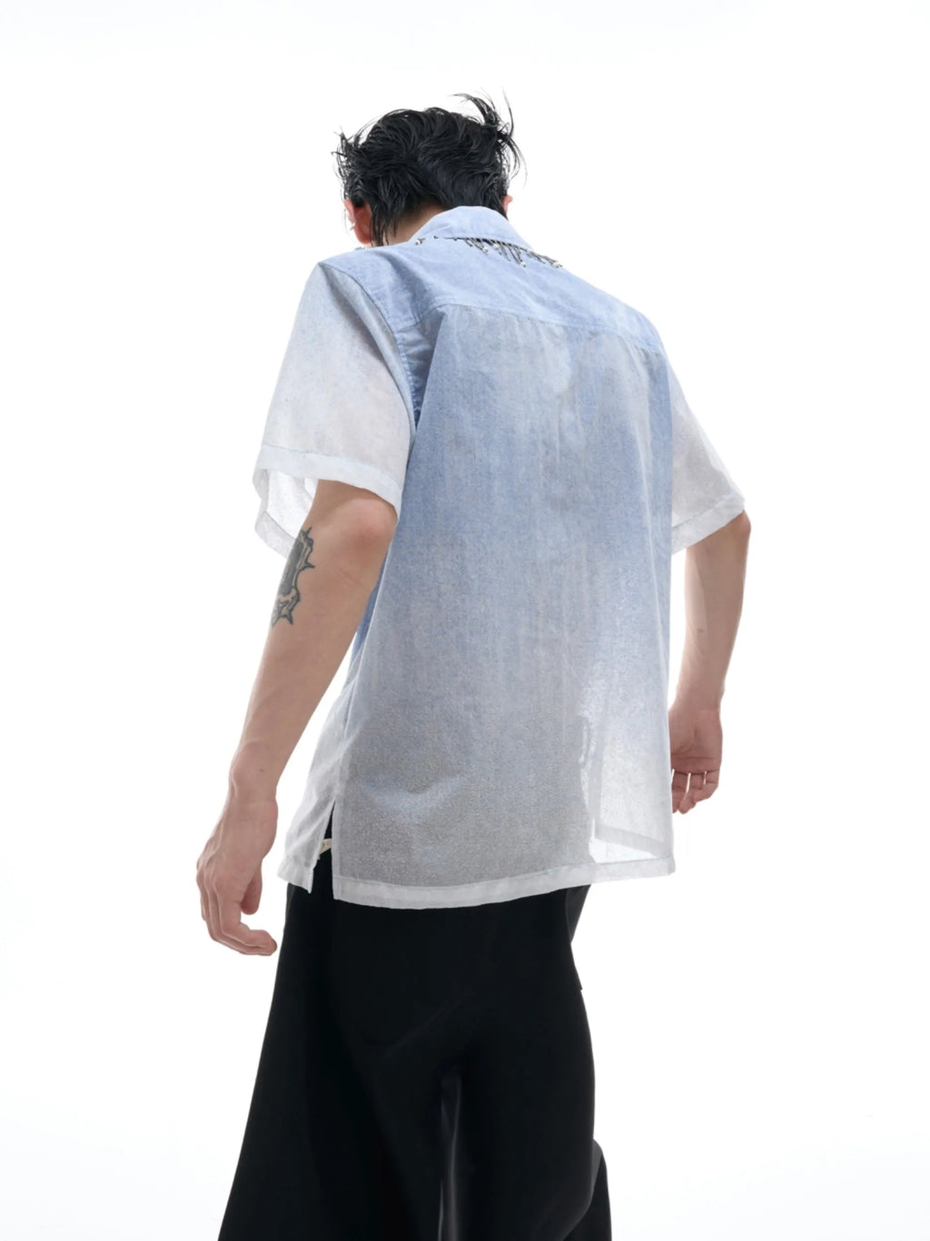 Man wearing a blue and white gradient loose fit short sleeve polyester summer shirt