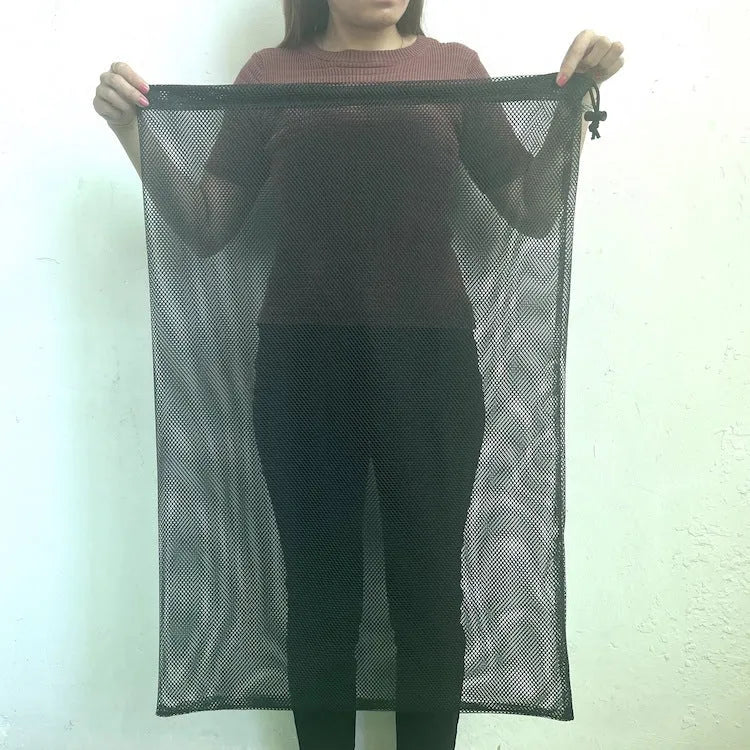 Black mesh drawstring storage bag with open bottom for toy organisation