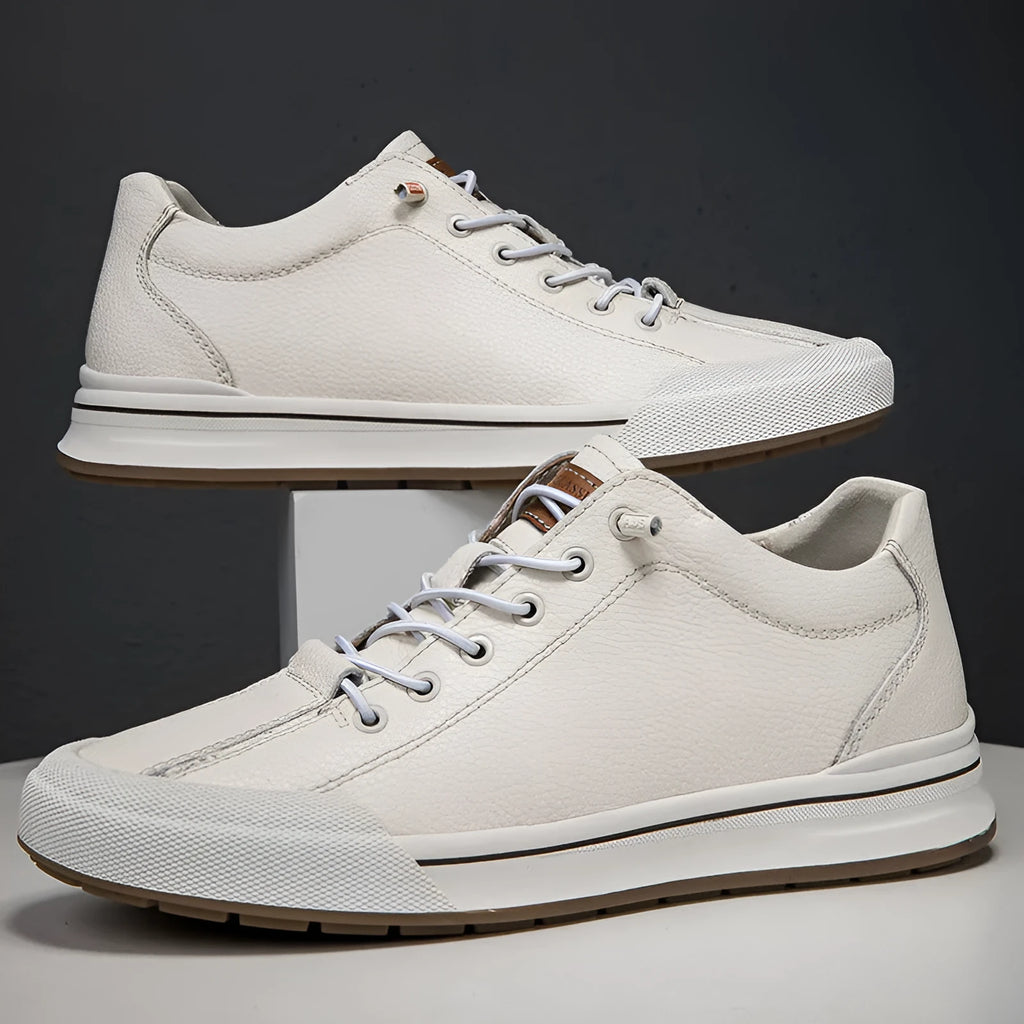 Men's white leather casual shoes with flat heel and round toe on a plain background