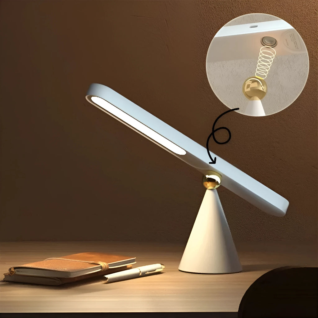 White geometric table lamp with touch switch and USB cable on a wooden desk.