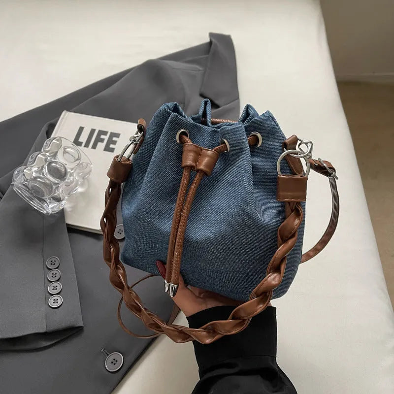 Blue synthetic leather cross-body bucket bag with adjustable strap and sandwich pocket