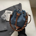Blue synthetic leather cross-body bucket bag with adjustable strap and sandwich pocket