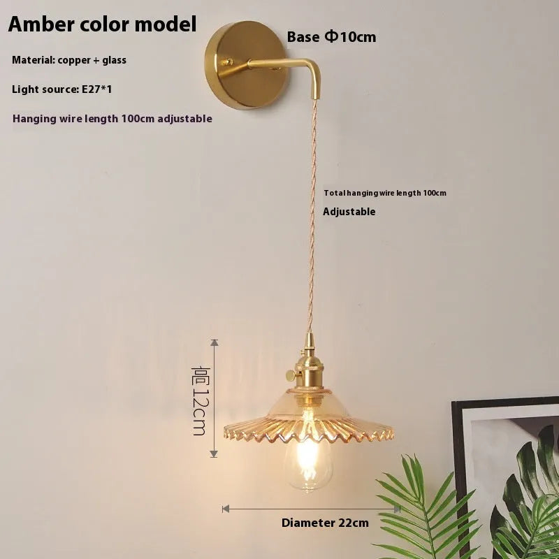 Retro brass lotus wall lamp with a glass shade in a choice of six colours.