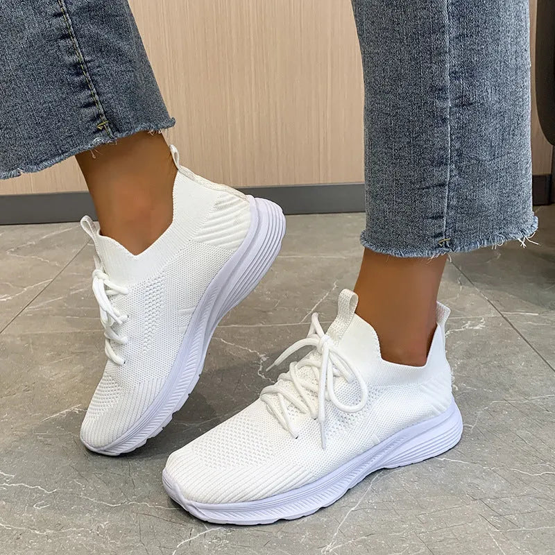Women's low-top mesh running shoes in creamy white with a rubber sole and round toe.