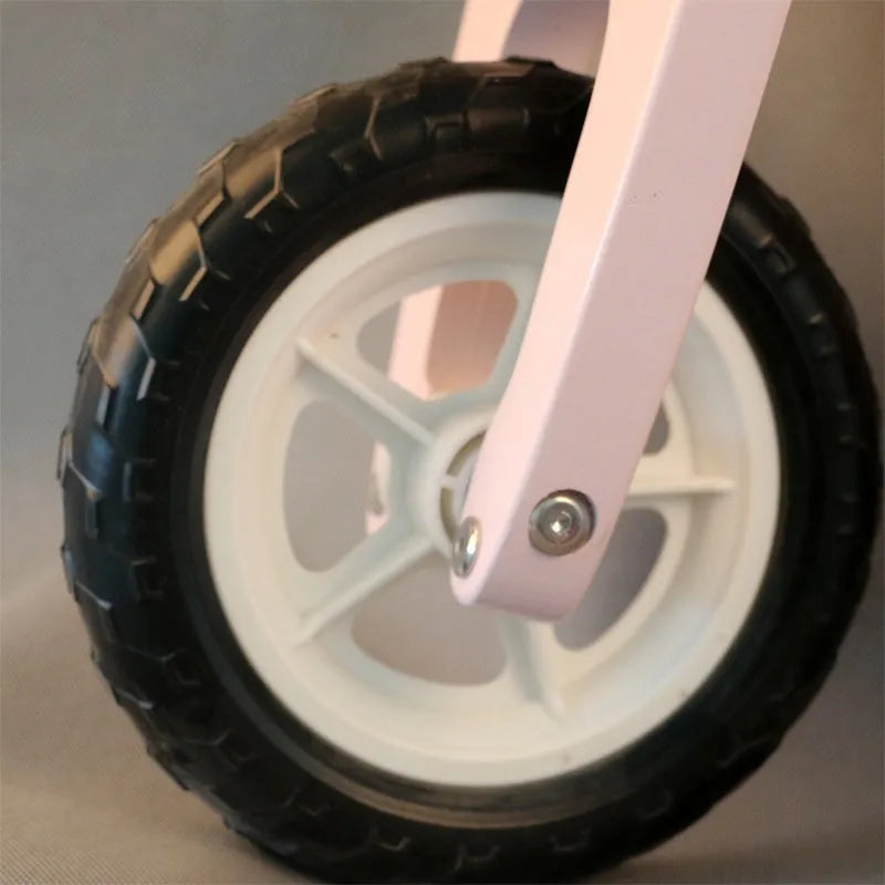 Pink wooden toddler balance scooter on a 10-inch wooden deck for children ages 1 to 6.