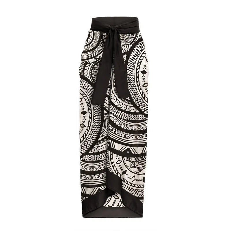 Women's vintage print one-piece swimsuit with deep V-neck, ruffles, and a matching wrap skirt.