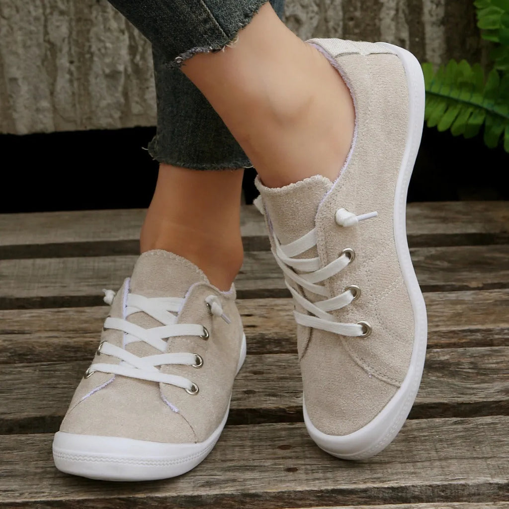 Women's creamy white low-top casual sneakers with fabric upper and rubber sole