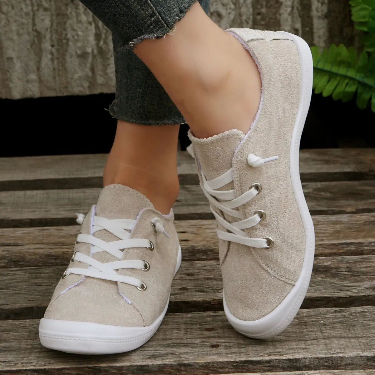 Women's creamy white low-top casual sneakers with fabric upper and rubber sole