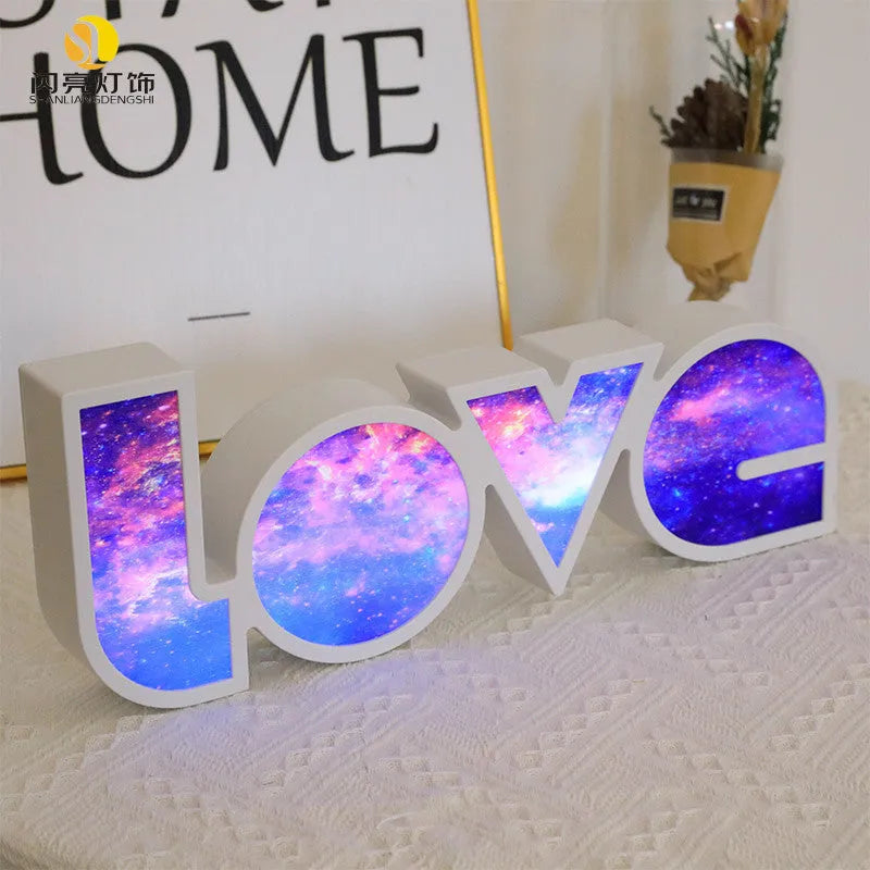 Colourful LED love light decorative lamp with plastic shell on a table