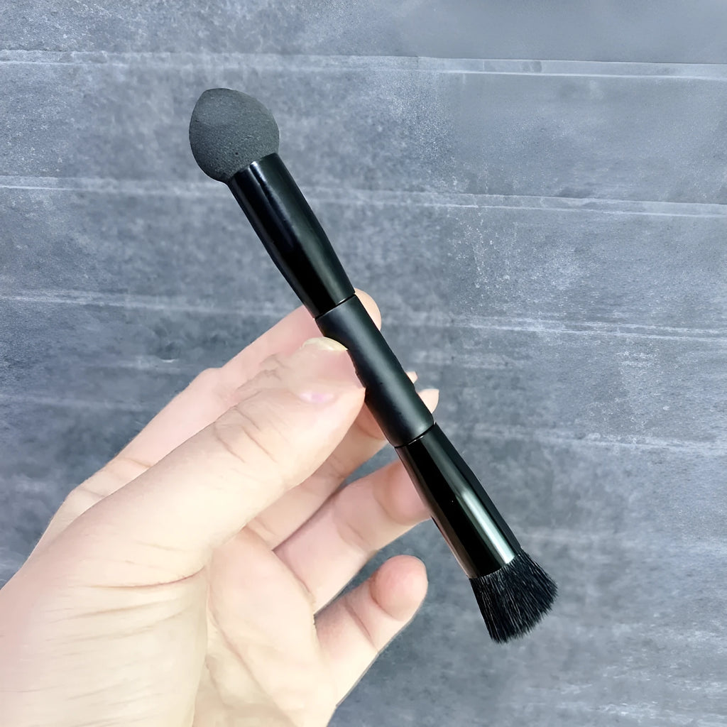 Black sponge tip concealer brush with a wooden handle for applying makeup to dark circles.